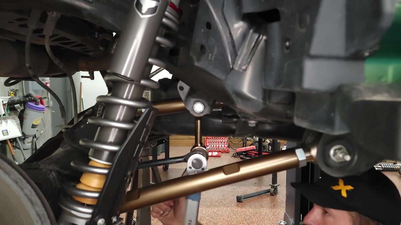 Completed rear sway bar end link install on the 2022 Ford Bronco, showing the new Core 4x4 Crawl Series end link with Johnny Joints connecting the sway bar to the rear axle