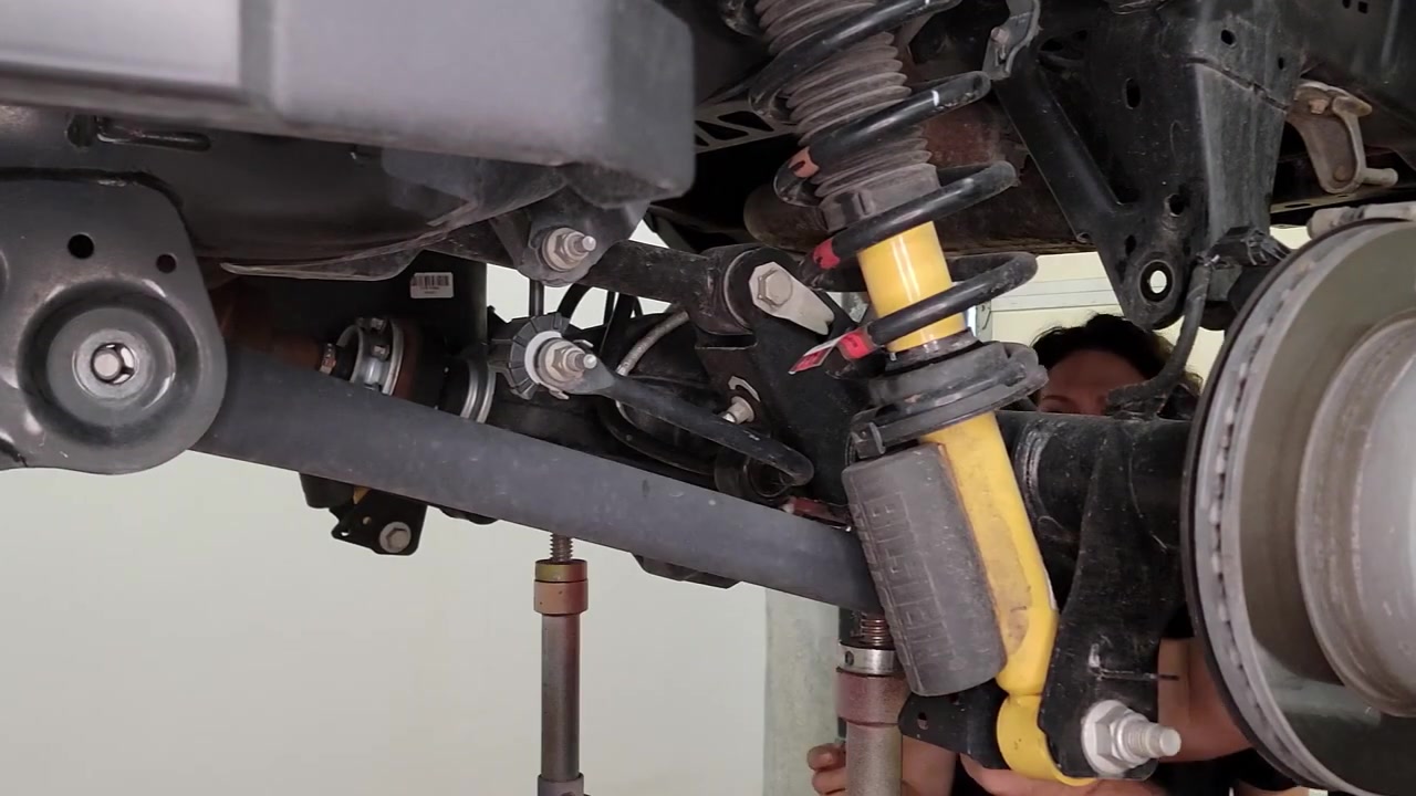 Rear suspension tear down in progress showing factory coilover and control arms on the 2022 Ford Bronco