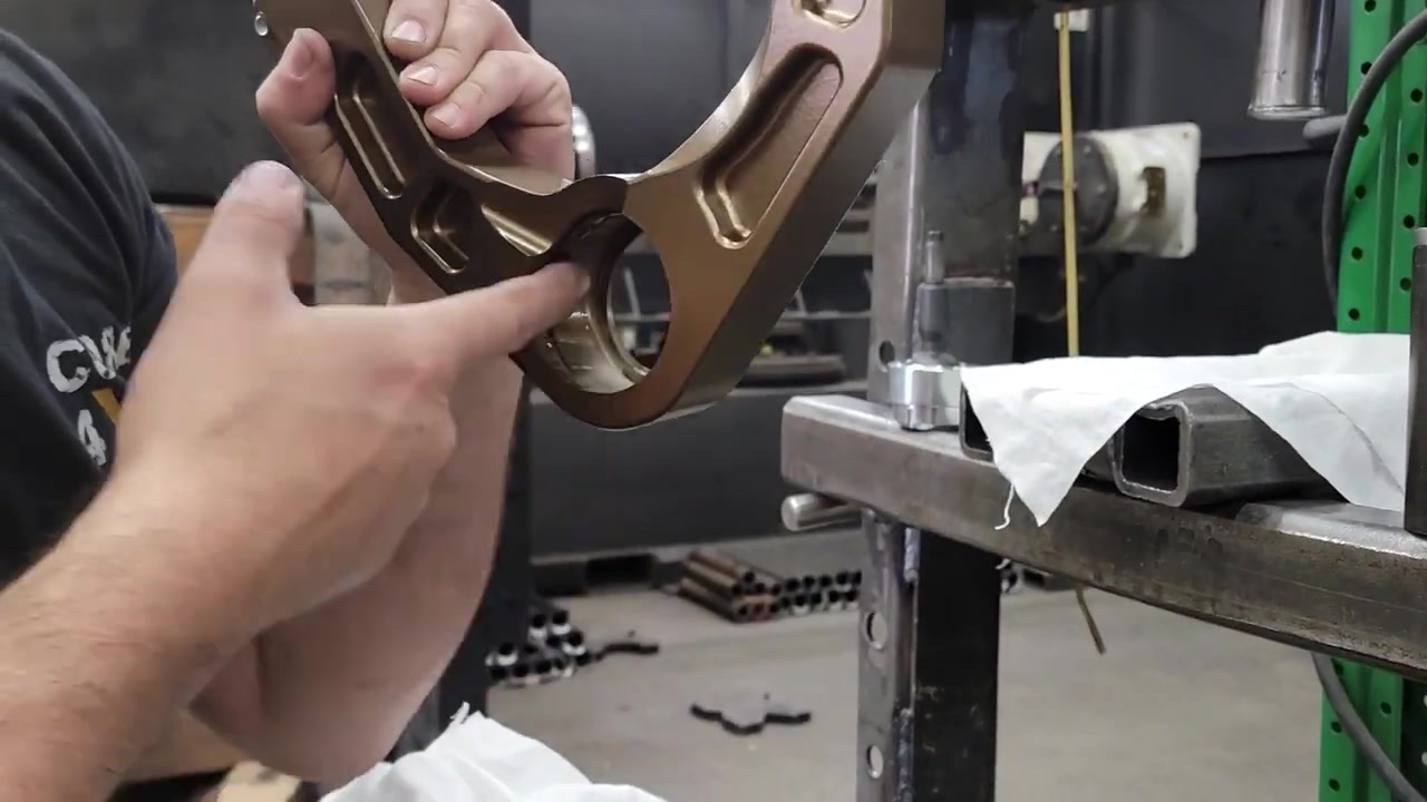 Freshly powder coated method bronze Icon billet aluminum upper control arm ready for assembly