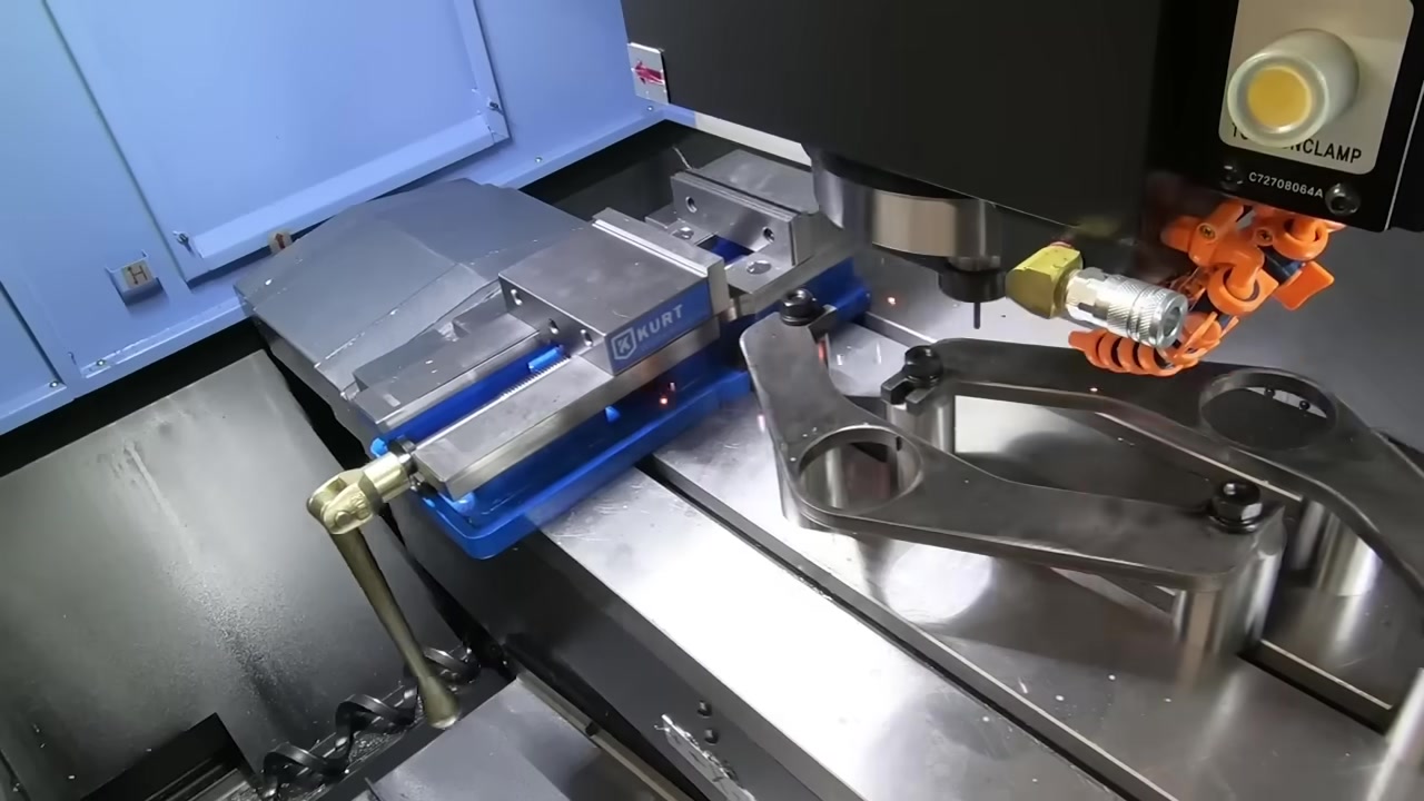 CNC milling machine cutting a precision control arm component in the Core 4x4 manufacturing facility