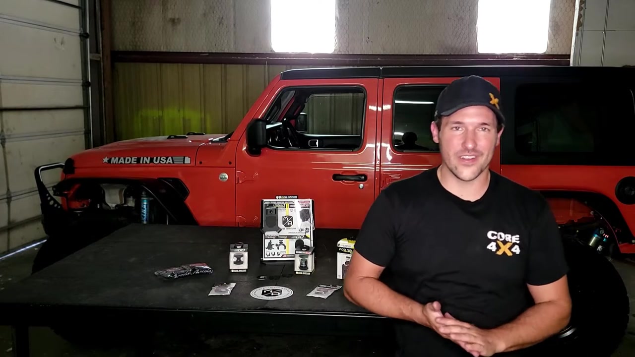 Spence in Core 4x4 shirt standing in front of red Jeep JL with Made in USA decal and Mob Armor products