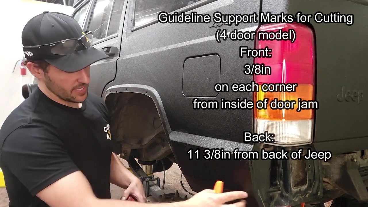 Spence marking the guideline support measurements on the XJ rear fender showing 3/8 inch from the door jamb on the front corners and 11-3/8 inches from the back of the Jeep on the rear