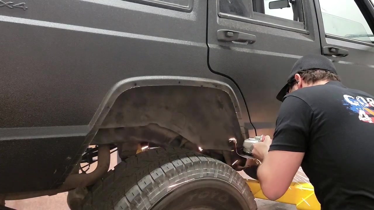 Spence drilling mounting holes in the rear fender of the XJ Cherokee for the fender flare support brackets