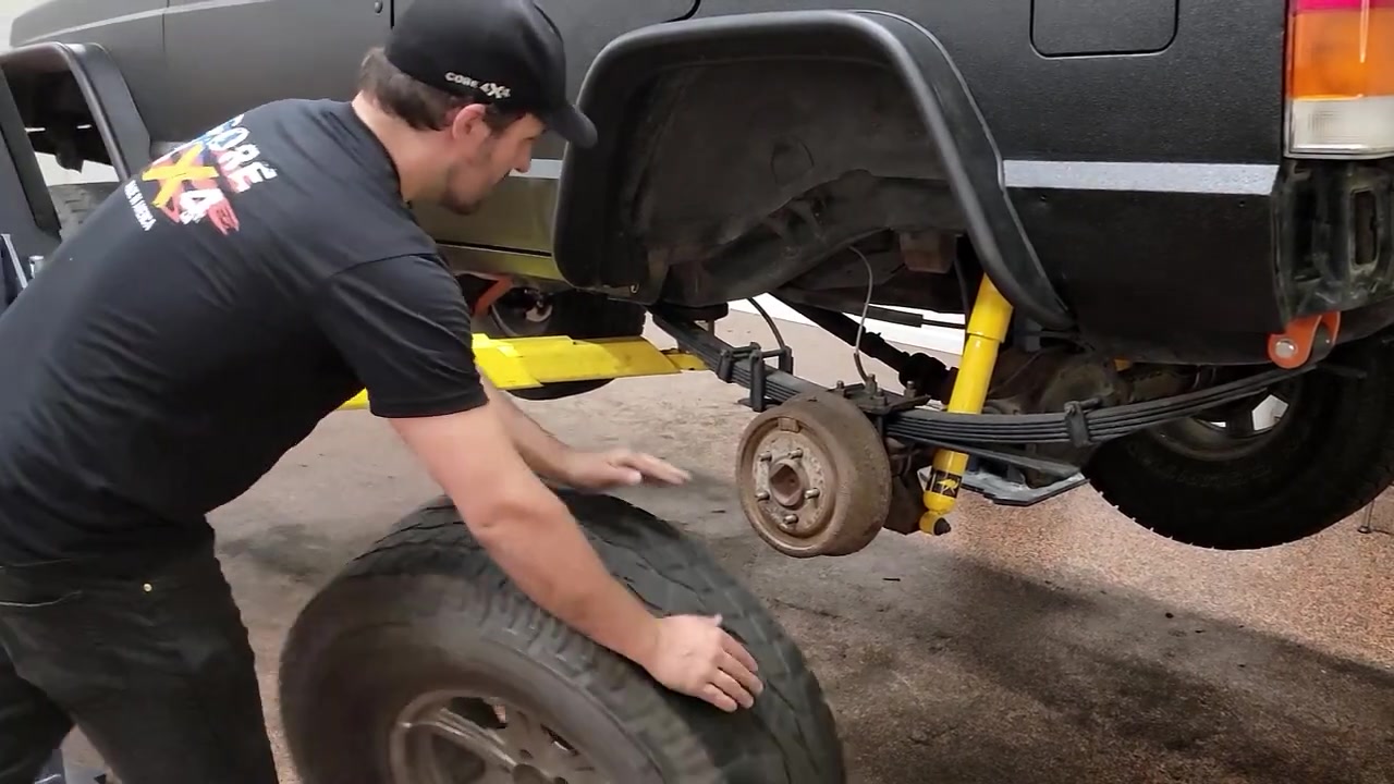 Spence checking the clearance between the tire and the newly installed rear fender flare on the XJ Cherokee