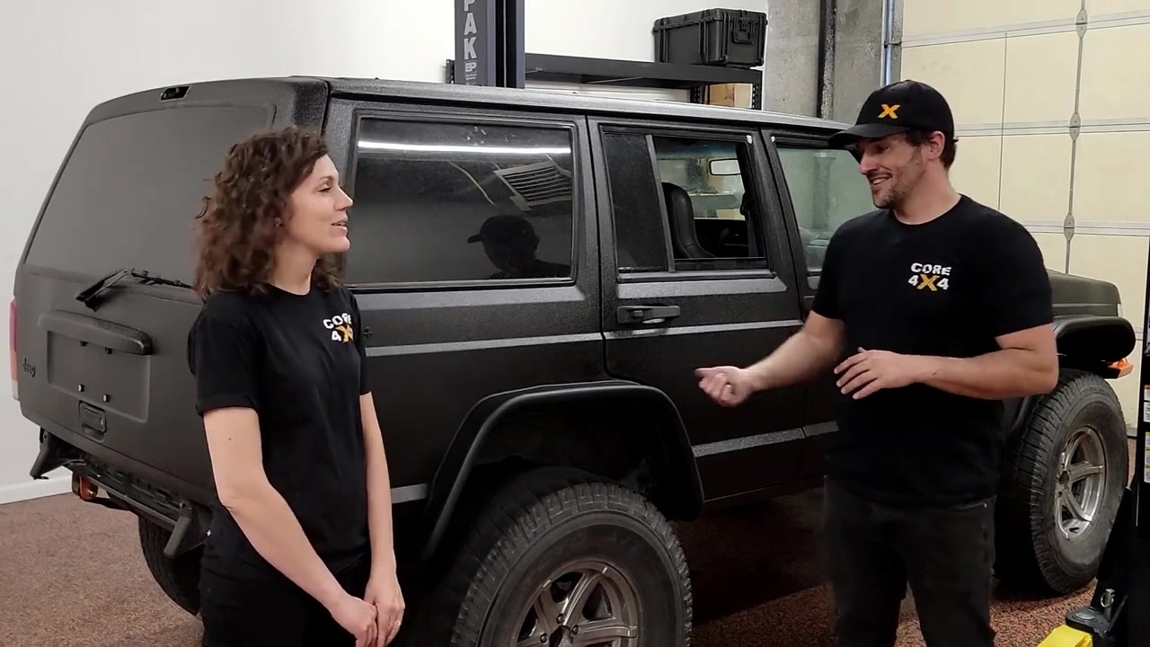 Spence and Marissa standing in front of the completed XJ Cherokee with the new rear fender flares installed showing the finished look