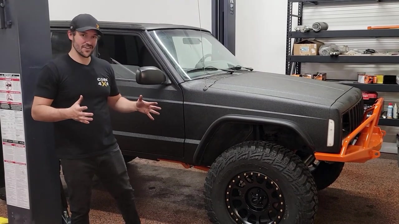 Spence standing next to the XJ Cherokee with new Method wheels and Kanati Mud Hog tires installed, XJ back on the ground