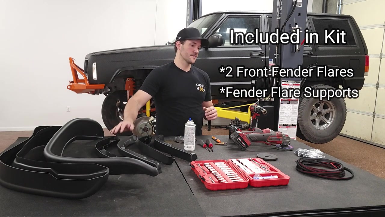Bushwacker flat fender flare kit contents laid out on shop table with fender flares, supports, seals, hardware, and required tools including drill, angle grinder, and socket set