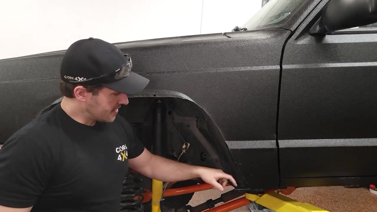 Spence showing the trimmed XJ fender opening with the wheel removed, fender support visible inside the wheel well
