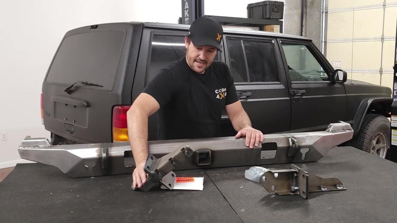 Spence inspecting the uncoated Dirtbound Highline bumper and bracket hardware laid out on the table