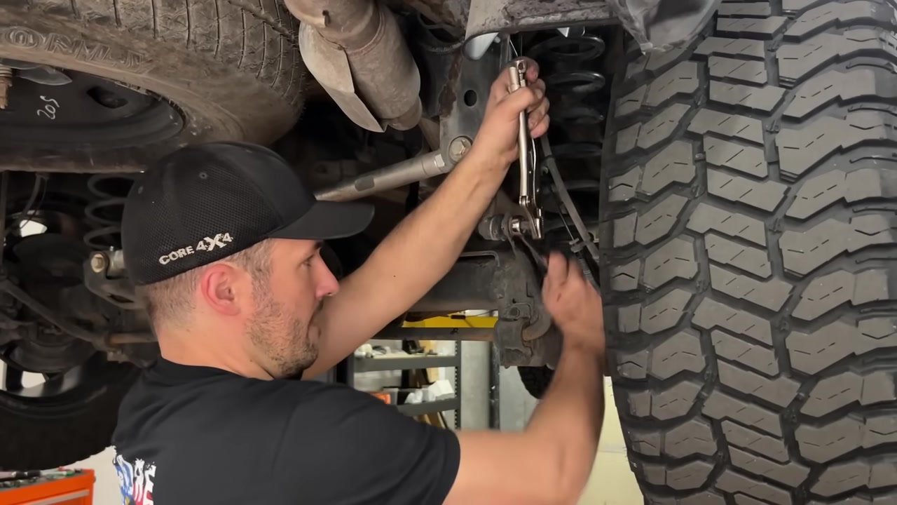 Spence installing the frame-side bolt on the new Core 4x4 end link underneath the Ram 1500