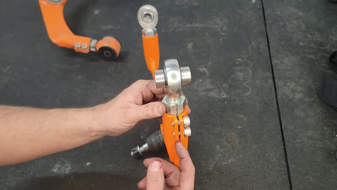 Close-up of the MOOG Problem Solver ball joint on the Core 4x4 upper control arm, showing the sealed cap and snap ring for easy serviceability