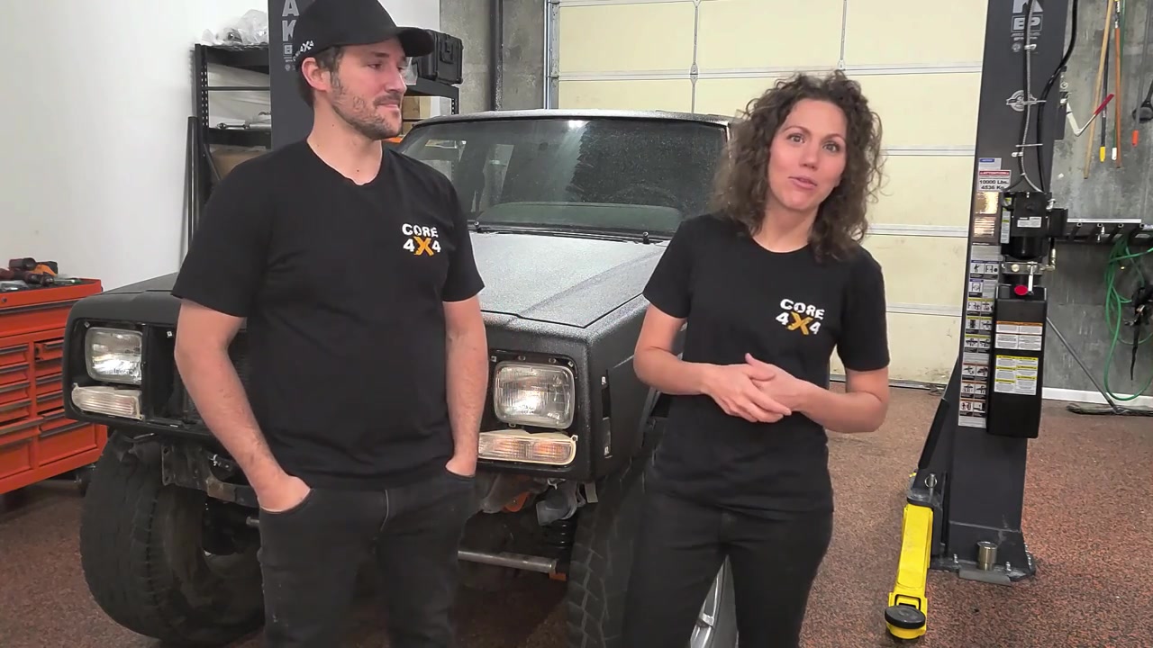 Spence and Marissa from Core 4x4 standing in front of the shop XJ Cherokee with no front bumper installed