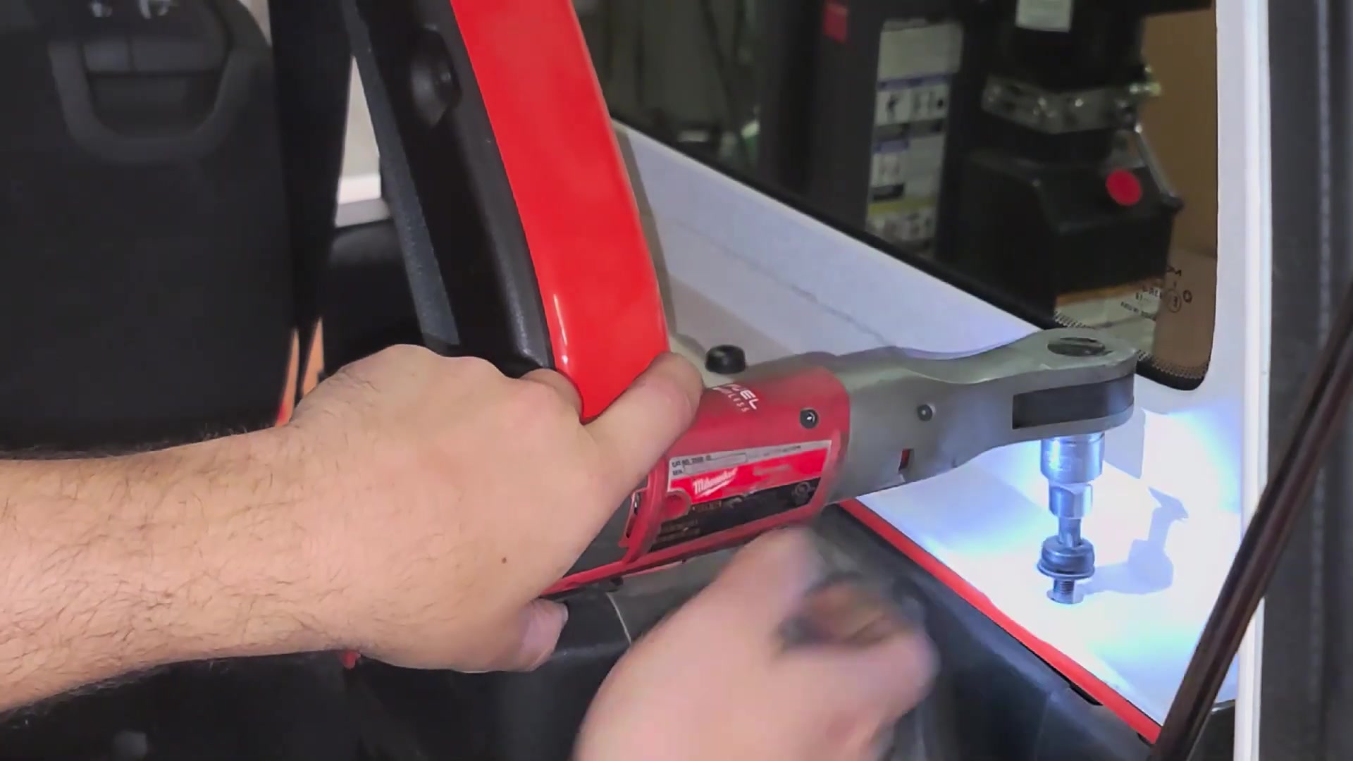 Removing hardtop bolts on the Jeep JL using a Milwaukee impact ratchet with T50 Torx bit