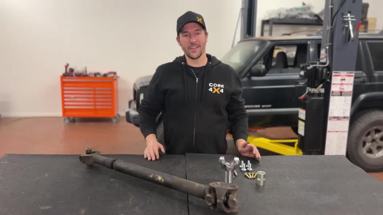Spence from Core 4x4 standing next to the lifted shop XJ Cherokee explaining the hack and tap process