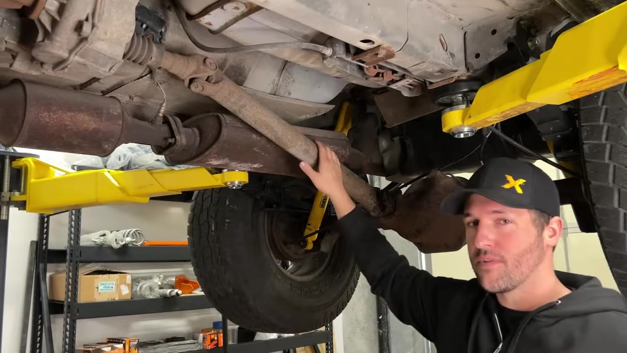 Underneath the XJ Cherokee showing the factory rear driveshaft slip yoke and steep angle from the 4-inch lift