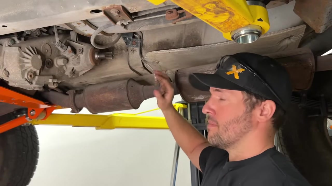 New fixed yoke bolted onto the transfer case output shaft with the junkyard front driveshaft being installed on the rear of the XJ
