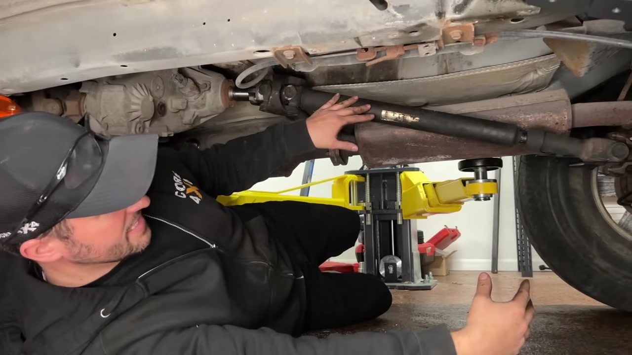 Spence checking driveshaft clearance and slip joint travel under the XJ Cherokee at ride height after the hack and tap install