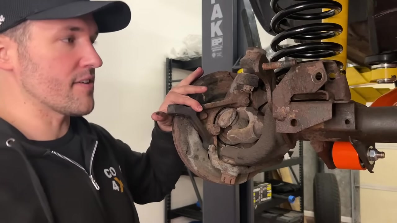 Close-up of the XJ Cherokee factory knuckle and hub assembly on the Dana 30 front axle