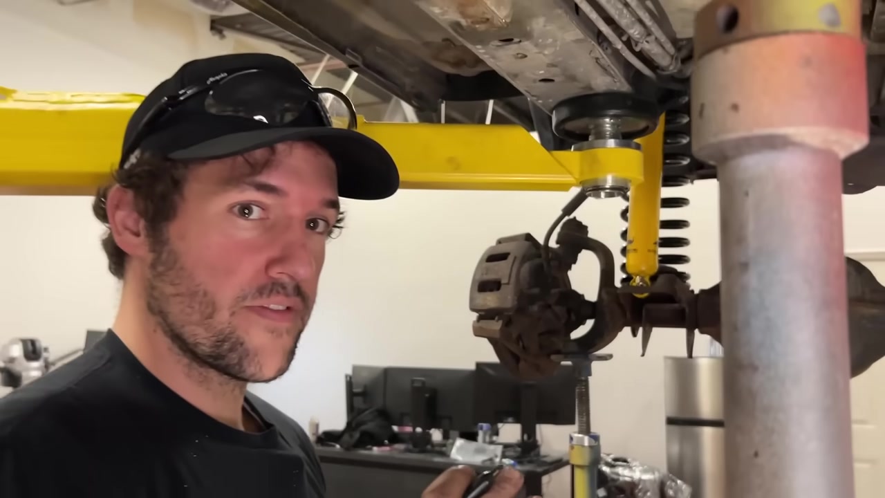 Spence under the XJ Cherokee marking and preparing the unibody for frame bracket drill holes