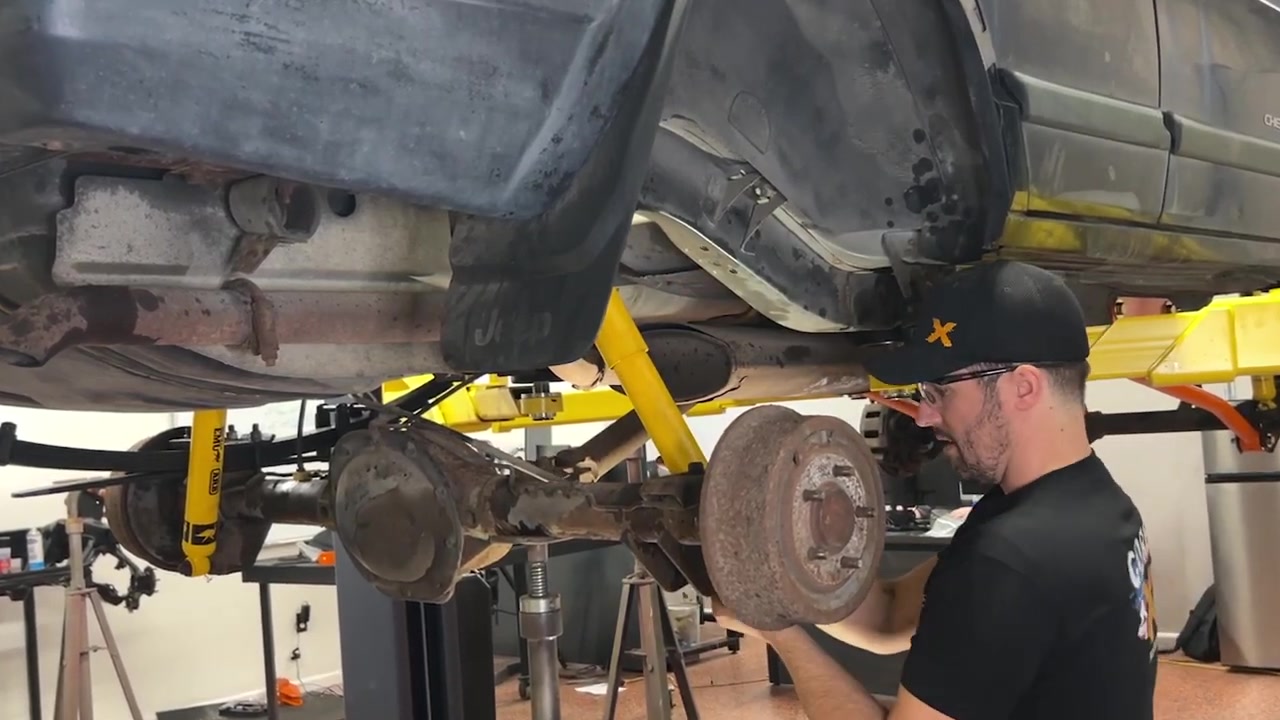Completed XJ Cherokee rear end with new leaf springs, shocks, and adjustable shackles installed