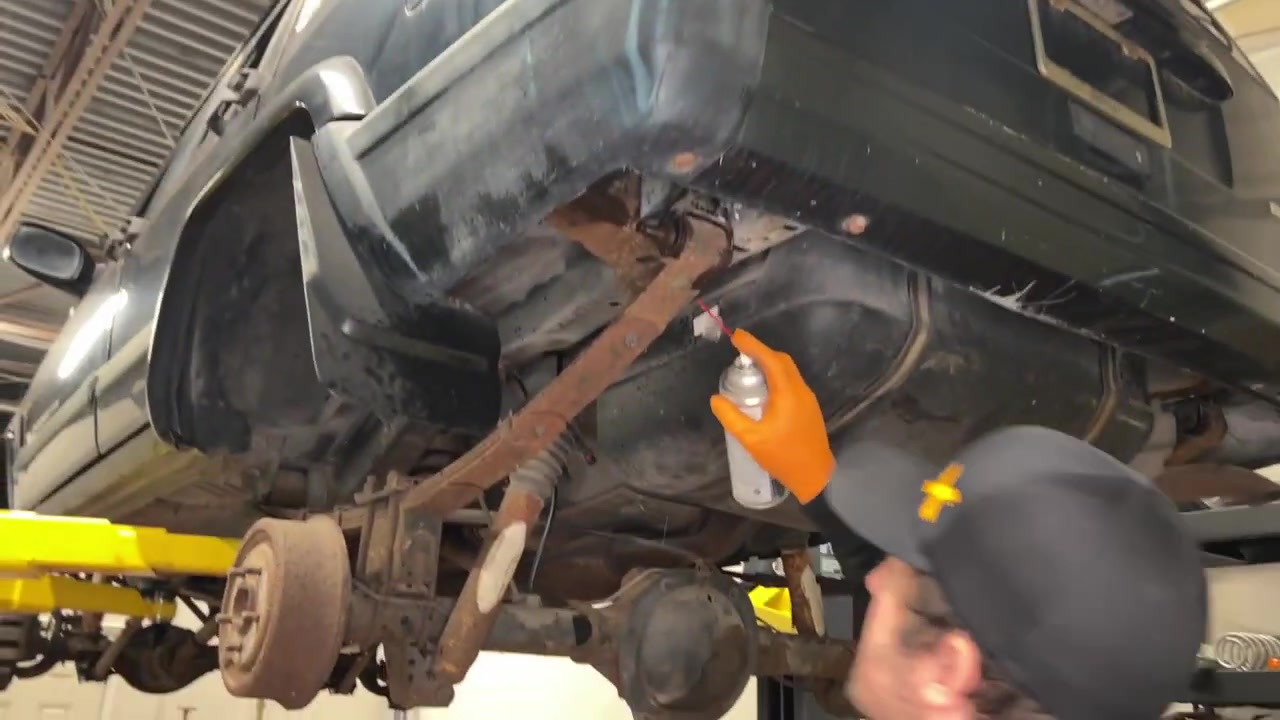 Spraying penetrating fluid on rusty XJ Cherokee front suspension components