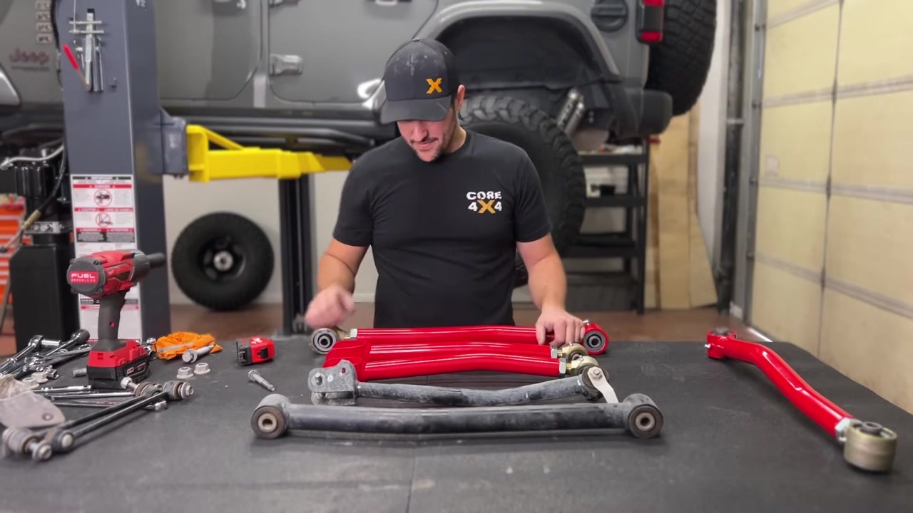 Close-up of Core 4x4 Crawl Series adjustable control arms being measured for correct length