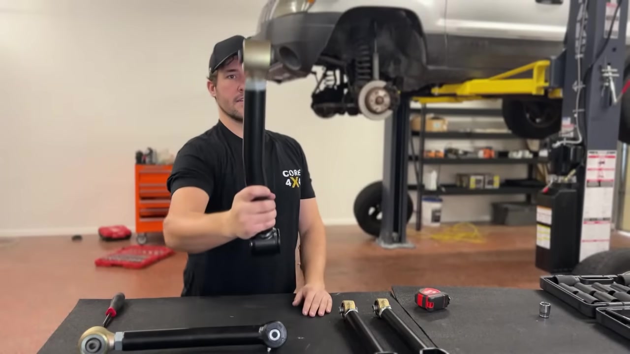 Spence at the workbench measuring and adjusting new Core 4x4 control arms to length for the WJ