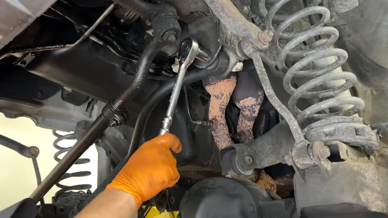 Installing new Core 4x4 adjustable control arm on the WJ Grand Cherokee under the lift