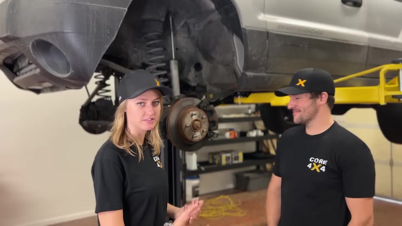 Gabby and Spence with the WJ on the lift, all new control arms and track bar installed