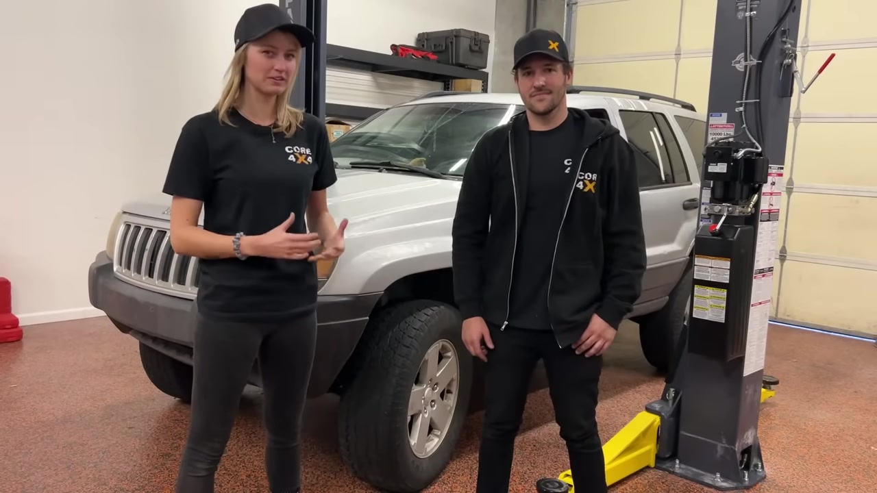 Gabby and Spence in front of the WJ Grand Cherokee after successfully fixing death wobble