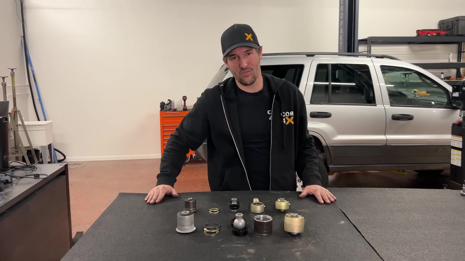 Spence at the Core 4x4 workbench with Johnny Joints, bushings, and rod ends laid out for comparison
