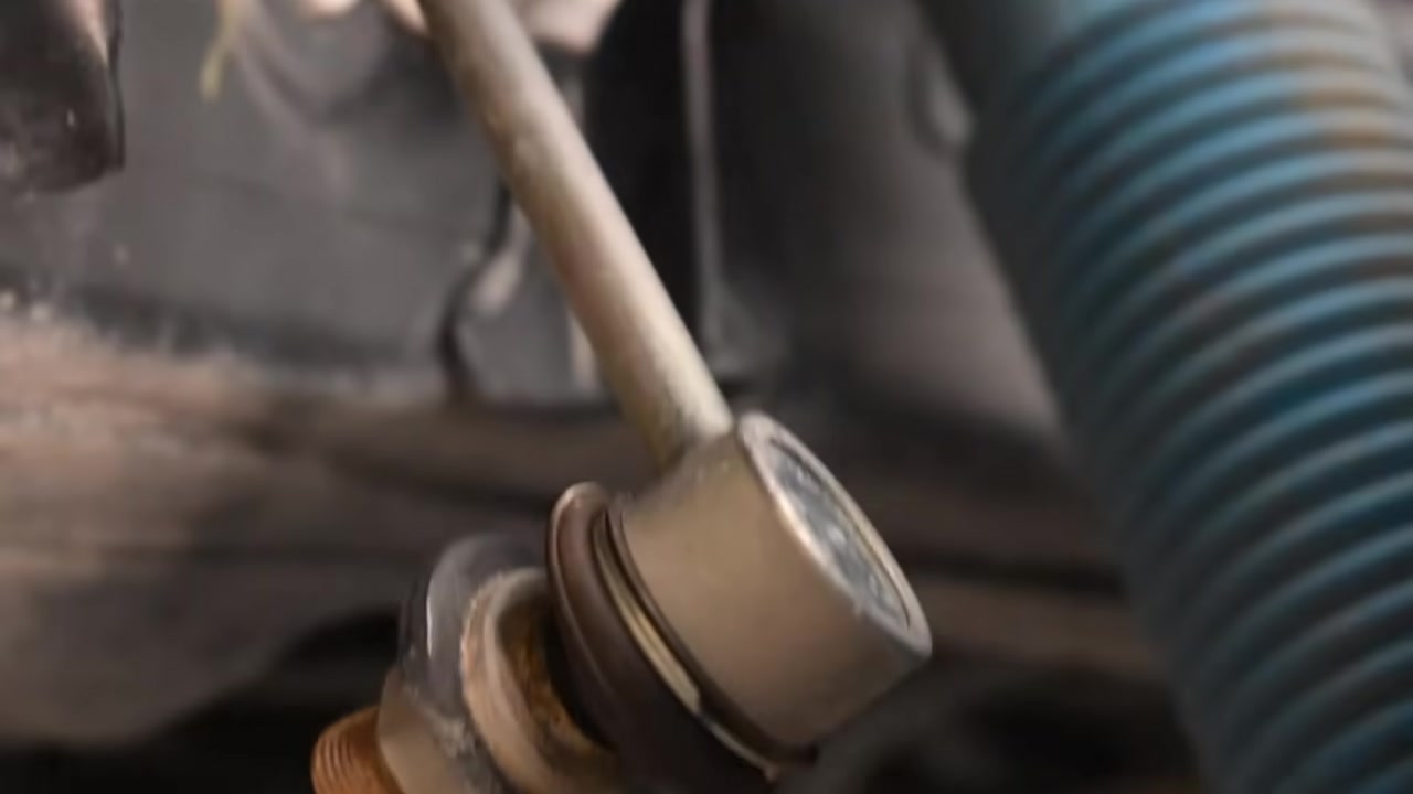 Close-up of a control arm bushing and joint underneath a Jeep showing the pivot point where the arm connects to the axle