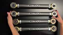 Four Core 4x4 Tier 4 adjustable control arms laid out on a black surface, showing forged ends and Johnny Joints on both sides