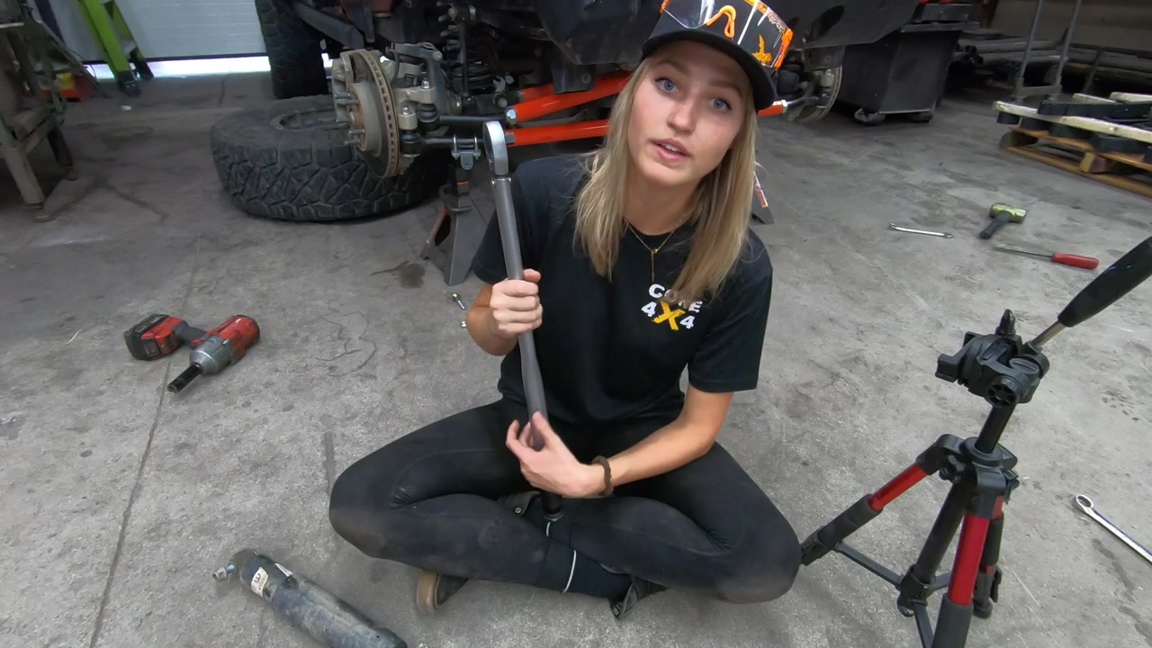 Gabby with a torque wrench explaining the 75 ft-lb torque spec for the steering kit rod ends
