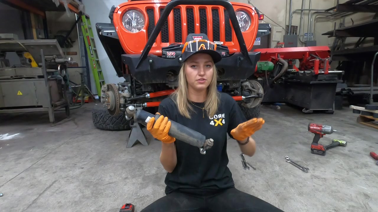 Gabby holding the new steering dampener that will be installed on the JL Wrangler