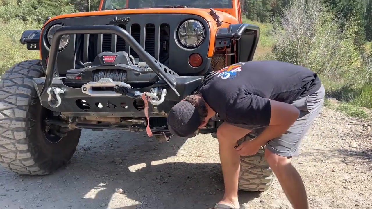 Jeep Wrangler navigating a rock obstacle on the Mineral Basin trail