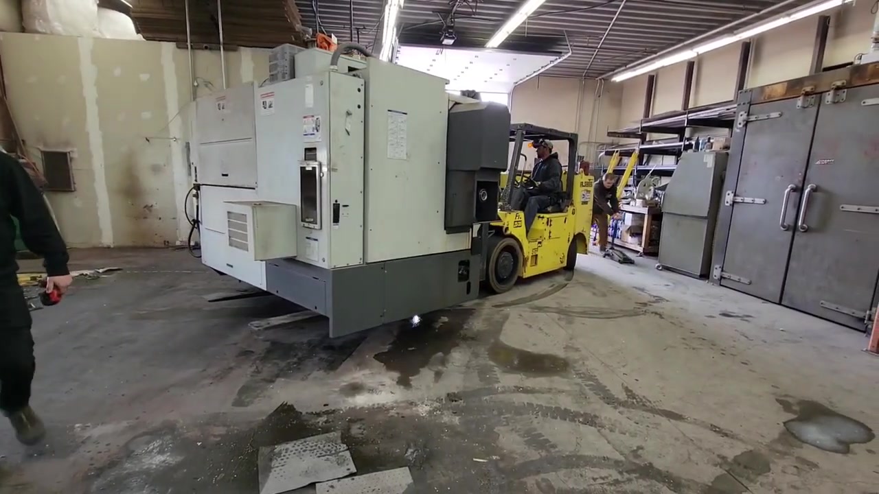 CNC machine being moved by rigging company into the new Core 4x4 facility