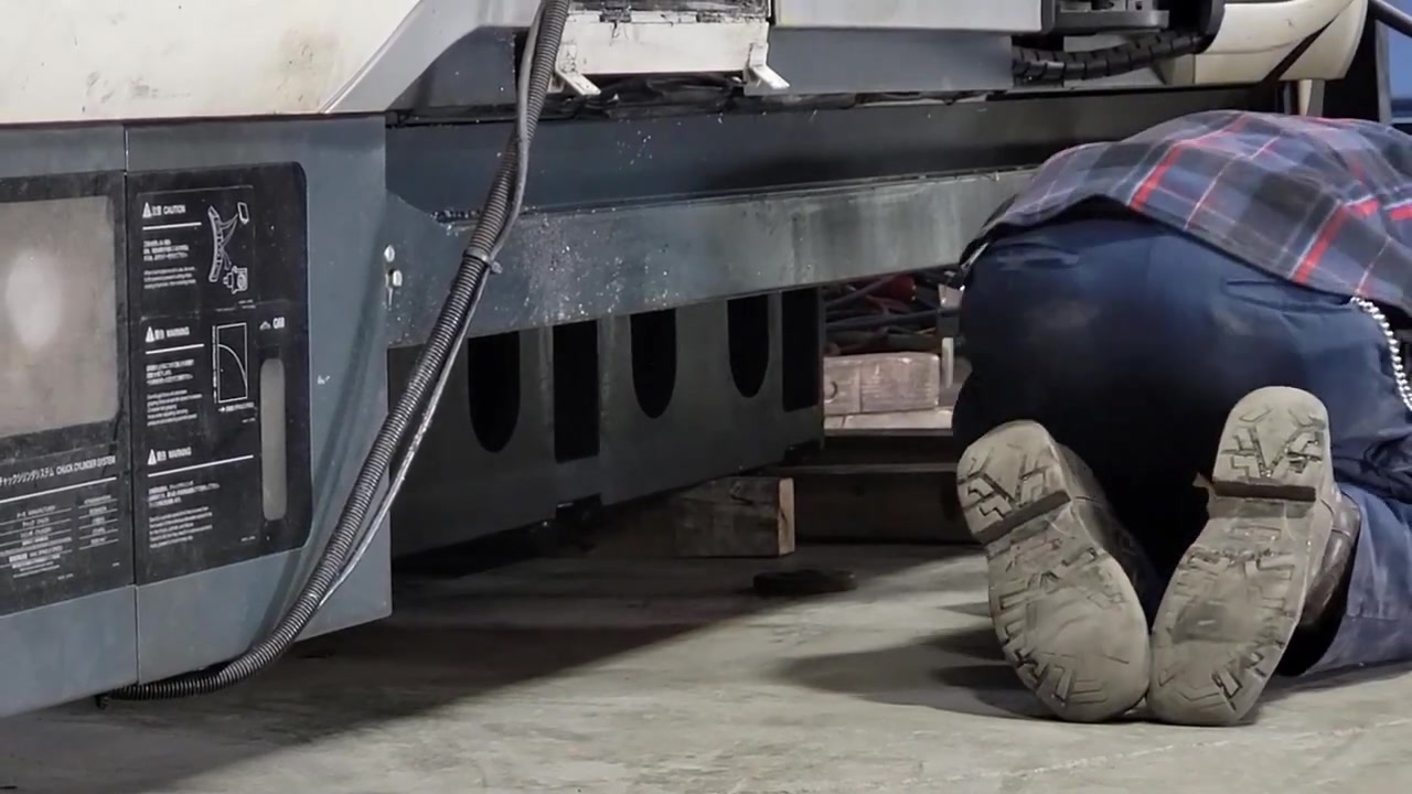 CNC technician leveling a machine in the new Core 4x4 manufacturing facility