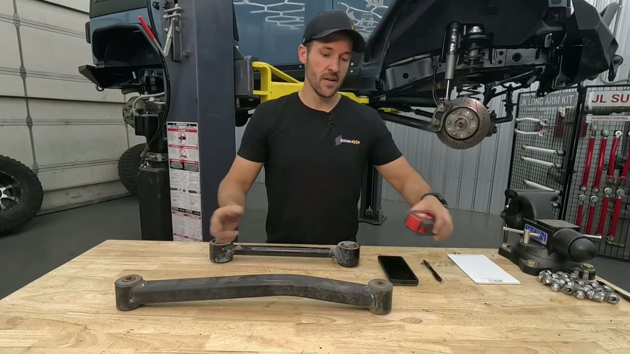 A bent Core 4x4 long arm laid flat on the workbench showing the side bend used for clearance