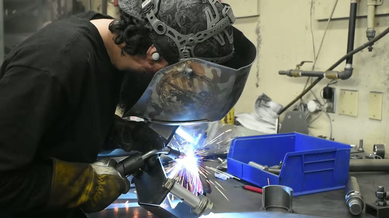 Core 4x4 welder TIG welding a custom control arm in the Orem, Utah fabrication shop